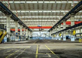 Expansive industrial warehouse interior showcasing steel framework and spacious layout for diverse manufacturing needs.